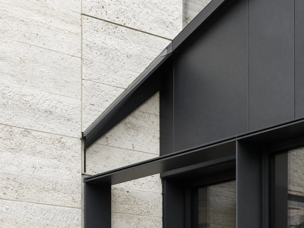 Architectural junction of finished dark metal and pale limestone — illustrative imagery, not a documented project